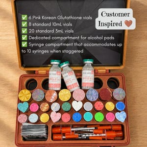 May include: An open storage case containing three glass vials with pink labels, multiple colorful circular and heart-shaped caps, a stack of small square packets, and several syringes with orange caps. Text lists contents including 6 pink Korean Glutathione vials, 8 standard 10mL vials, 20 standard 3mL vials, an alcohol pad compartment, and a syringe compartment.