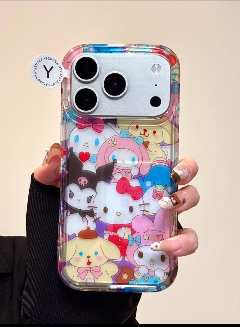 May include: Clear phone case featuring a colorful design with cartoon characters. The case has a variety of characters, including Hello Kitty, My Melody, and others. The case has a clear border and a sticker that says "Y2CASE".