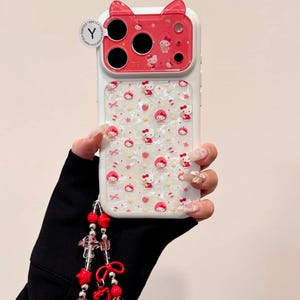 A hand holds the same Hello Kitty case, and a beaded wristlet hangs from the lower left side.