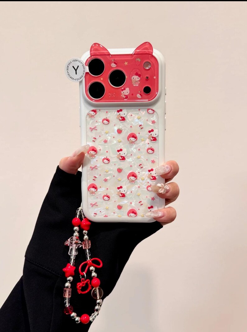 A hand holds the same Hello Kitty case, and a beaded wristlet hangs from the lower left side.