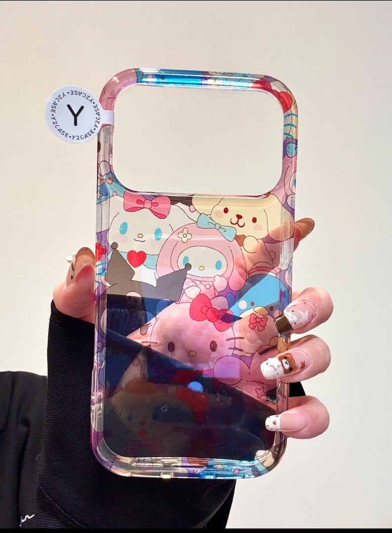 May include: Clear phone case featuring a colorful cartoon design with characters like My Melody and Hello Kitty. The case has a transparent border and a sticker that says "Y2CASE".
