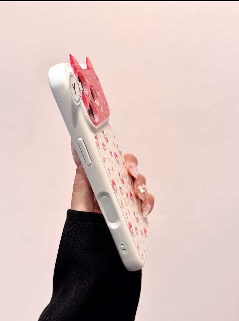 A side-profile view shows the thickness and buttons of the Hello Kitty case with the decorative back partially visible.