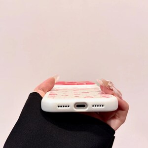 A bottom edge view shows the phone case's charging port cutout and speaker holes.