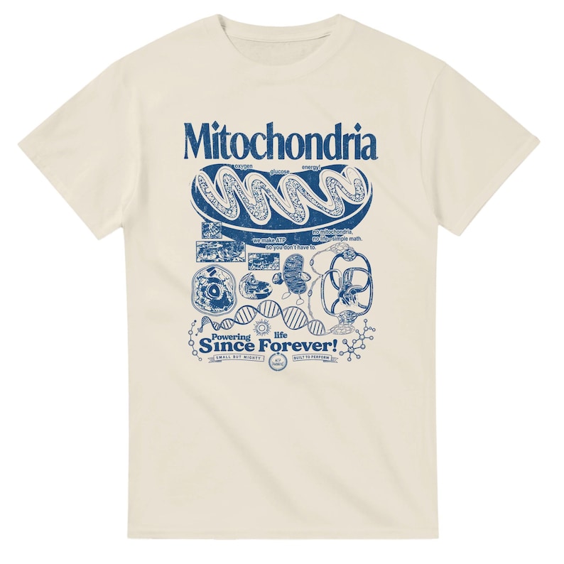 A cream-colored short-sleeve t-shirt with a blue graphic of a mitochondria cell and related scientific diagrams and text.
