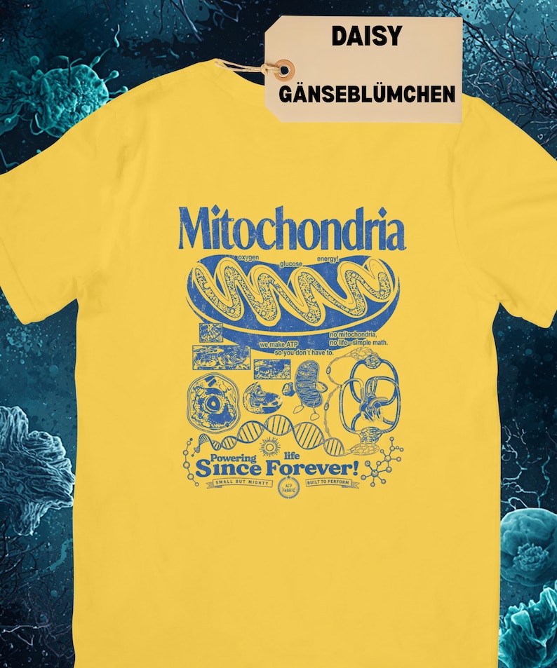 A yellow short-sleeve t-shirt with a blue graphic of a mitochondria cell and related scientific diagrams and text, with a brown tag that says "DAISY GÄNSEBLÜMCHEN."