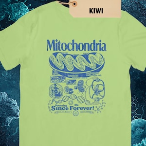 A light green short-sleeve t-shirt with a blue graphic of a mitochondria cell and related scientific diagrams and text, with a brown tag that says "KIWI KIWI."