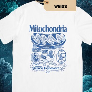A white short-sleeve t-shirt with a blue graphic of a mitochondria cell and related scientific diagrams and text, with a brown tag that says "WHITE WEISS."