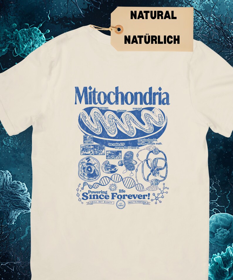 A cream-colored short-sleeve t-shirt with a blue graphic of a mitochondria cell and related scientific diagrams and text, with a brown tag that says "NATURAL NATÜRLICH."