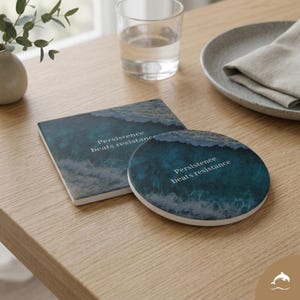 May include: A square and round coaster set with a teal ocean wave design. The coasters have the text "Persistence beats resistance" in white. The coasters are on a light wood table.