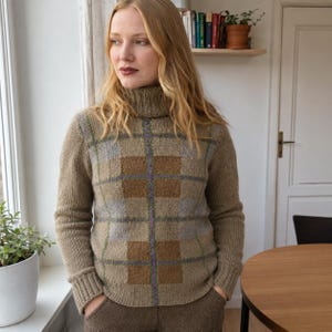 Op de afbeelding: Een trui met lange mouwen en een col, uitgevoerd in een beige basiskleur met een groot ruitpatroon in tinten bruin, lichtgrijs en dunne paarse lijnen. Het gebreide kledingstuk heeft een geribbelde kraag, geribbelde boorden en een geribbelde zoom.