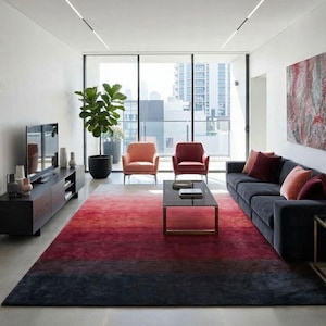May include: Modern living room with a large, dark gray sofa, two armchairs, and a rectangular coffee table. A large rug transitions from red to black. A large window offers a view of the city.