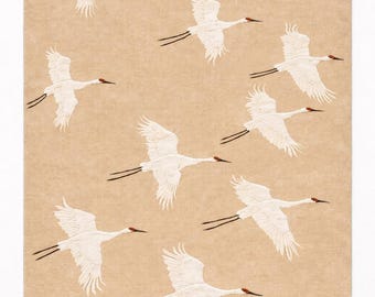 May include: A beige rectangular artwork depicting a flock of white cranes in flight. Each crane has black wing tips and a red head. The birds are evenly spaced across the artwork.