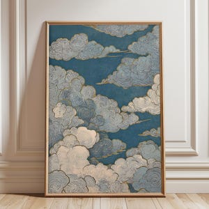 May include: Framed art print featuring a stylized depiction of clouds. The artwork showcases swirling, textured clouds in shades of white, gray, and blue against a deep blue background. The frame is a light wood color, adding a natural touch to the piece.