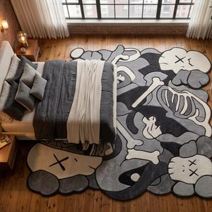 May include: A large, irregularly shaped area rug featuring a monochromatic graphic design in shades of black, grey, and white. The pattern includes stylised skull-like figures with X-shaped eyes and skeletal bone motifs across the surface.