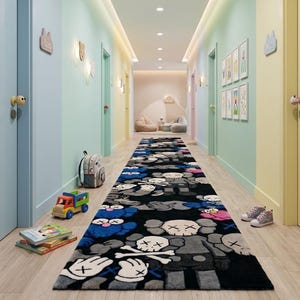 May include: A long rectangular runner rug featuring a repeating pattern of stylized cartoon characters with X-shaped eyes and skull heads in shades of black, gray, blue, and pink, laid out on a light wood floor in a hallway with colorful pastel walls.