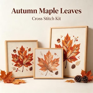 May include: Three framed cross stitch projects featuring autumn maple leaves, acorns, and pinecones in shades of orange, red, and brown on light fabric. The text Autumn Maple Leaves Cross Stitch Kit is displayed above the framed artwork.