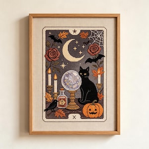 May include: A framed cross-stitch embroidery featuring a black cat sitting next to a crystal ball, a jack-o'-lantern, a potion bottle, and a crow. The scene includes a crescent moon, stars, bats, spiderwebs, roses, and autumn leaves in a tarot card style.