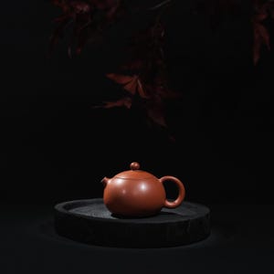 May include: A set of three ceramic mugs with a speckled, matte finish. The mugs are in shades of cream, light gray, and dark gray. Each mug has a simple, minimalist design and a rounded handle. Perfect for coffee or tea.