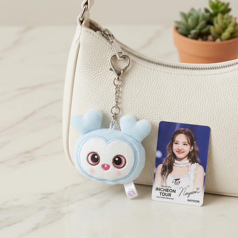 Twice's 6th Incheon World Tour LOVELY Keychain - 8cm Plush Bag Charm - Jihyo (yellow), Nayeon (blue), Momo (pink), and all members. Nayeon