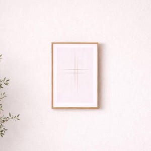 May include: A framed print with a minimalist design of intersecting gold lines on a white background. The artwork is encased in a light wood frame. The overall aesthetic is clean and modern, suitable for contemporary interiors.
