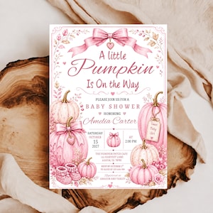 May include: A rectangular baby shower invitation card featuring watercolor pink pumpkins, a large pink bow at the top, and floral accents. The text reads A little Pumpkin Is On The Way, Please Join Us For A Baby Shower Honoring Amelia Carter, Saturday October 15 2027 at 2:00 PM, The Pumpkin Patch Cafe 123 Harvest Lane Austin TX, RSVP by October 1 to Alice at 123-456-789, Registered at Amazon and Target.