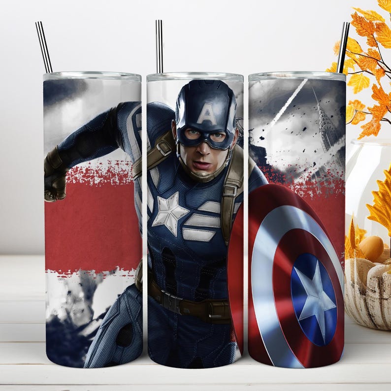 May include: A cylindrical stainless steel tumbler featuring a graphic print of Captain America in a blue suit with a white star emblem, a mask with an A, and a red, white, and blue circular shield. The design includes a red horizontal stripe.