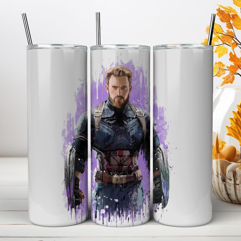 May include: A cylindrical white tumbler featuring a graphic illustration of a bearded man in a dark blue tactical suit with metallic armor accents, set against a purple watercolor-style splash background, complete with a thin metal straw.