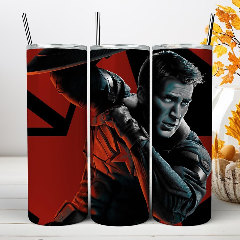 May include: A cylindrical stainless steel tumbler featuring a graphic print of Captain America in a dark blue suit with a red star emblem. The background is a bold red and black geometric design. The tumbler includes a clear lid and a metal straw.