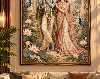 May include: A framed wall art print depicting a blue-skinned figure playing a flute alongside a woman in a pink and gold sari. They stand in a garden with lotus flowers and two peacocks. The scene features golden halos and ornate clothing.