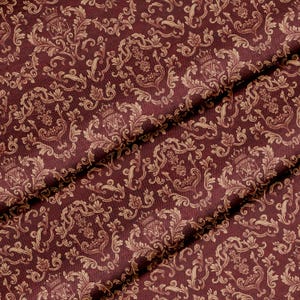 May include: A deep burgundy fabric featuring a repeating damask pattern in a light tan color. The design includes intricate scrolling floral motifs and a central emblem topped with a crown, creating a dense, symmetrical, and ornate visual texture.