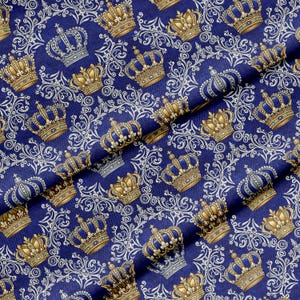 May include: Royal blue fabric with a repeating pattern of gold and blue crowns, interspersed with white ornate scrollwork. The crowns have intricate details and are set against a dark blue background.