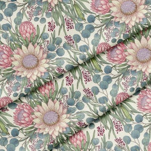 May include: Floral fabric featuring a repeating pattern of pink protea flowers, green leaves, and blue-green eucalyptus leaves on a cream background. The design has a watercolor effect, creating a soft and natural aesthetic.