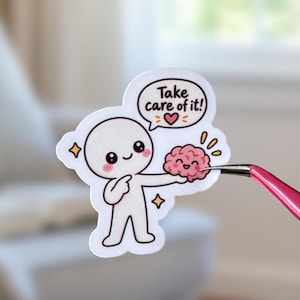 Peut inclure: Un autocollant découpé représentant un personnage de dessin animé blanc au visage souriant tenant un petit cerveau rose. Au-dessus se trouve une bulle avec le texte Take care of it! et un petit cœur rouge. L'autocollant a une bordure blanche.
