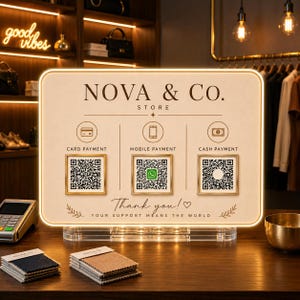 May include: A rectangular, illuminated payment sign for Nova & Co. Store featuring three sections for card, mobile, and cash payments with QR codes. The sign includes the text 'Thank you! Your support means the world' and sits on a clear acrylic base.
