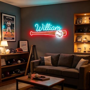May include: A wall-mounted neon sign featuring the name William in bright cyan script above a red and white baseball bat and ball graphic. The sign emits a vibrant glow against the dark wall, serving as a decorative piece in a room.