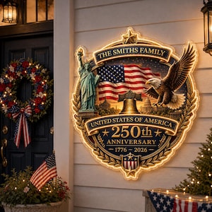 May include: A lighted patriotic sign with the text "The Smiths Family" and "United States of America 250th Anniversary 1776-2026." The sign features the American flag, the Statue of Liberty, an eagle, and the Liberty Bell.