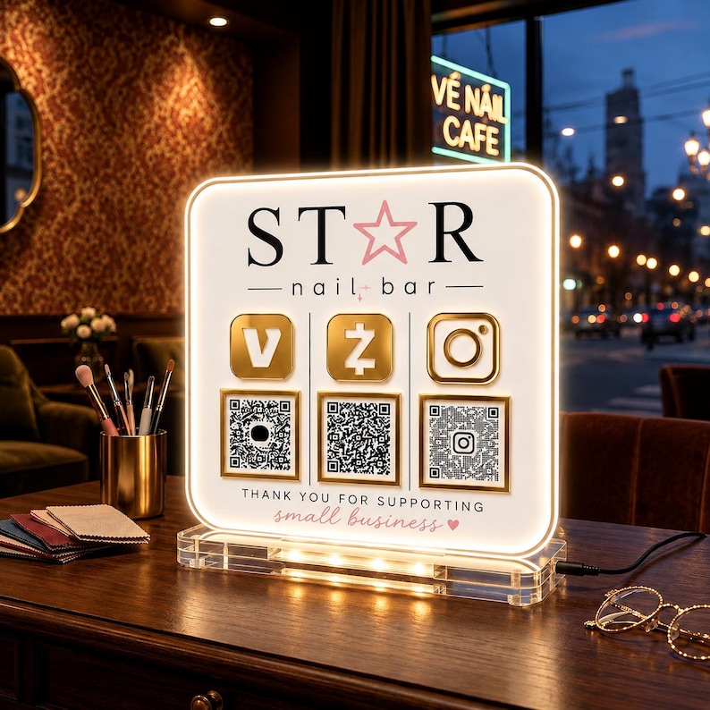 May include: A square, illuminated acrylic sign featuring the text STAR nail bar, three gold social media icons, and three corresponding QR codes. The bottom text reads THANK YOU FOR SUPPORTING small business with a small heart icon.