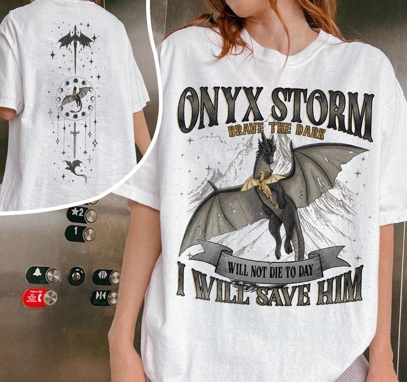 May include: White t-shirt featuring a black dragon graphic with the text "ONYX STORM BRAVE THE DARK" and "I WILL SAVE HIM". The back of the shirt has a matching dragon design.