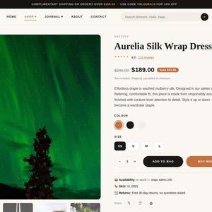 May include: A product page for the Aurelia Silk Wrap Dress by Veloura, featuring a large image of the aurora borealis, product title, price of $189.00, color selection options, size buttons from XS to L, and Add to Bag and Buy Now buttons.