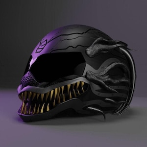 May include: Black motorcycle helmet with a menacing design. The helmet features a textured surface, a dark visor, and gold-colored teeth. It has black, tentacle-like accents on the sides and top, creating a striking, aggressive look.