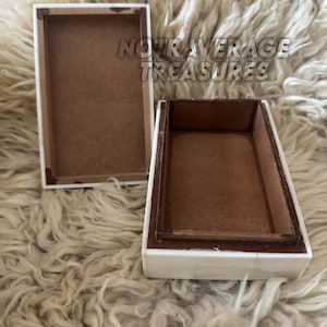 May include: A rectangular box with a white exterior and a brown interior, shown with its lid removed and placed beside it. The text NOT AVERAGE TREASURES is visible in the center. The box features a clean, simple design with a flat base and lid.