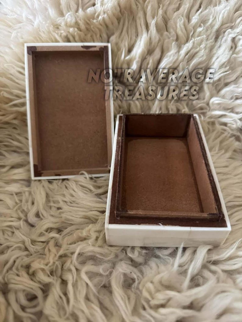 May include: A rectangular box with a white exterior and a brown interior, shown with its lid removed and placed beside it. The text NOT AVERAGE TREASURES is visible in the center. The box features a clean, simple design with a flat base and lid.