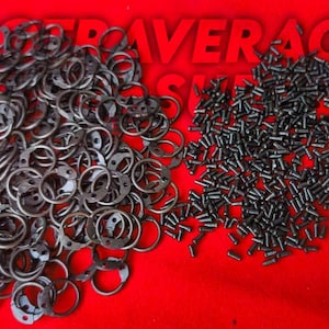 May include: A red background with two piles of metal hardware. One pile consists of circular pieces with holes and rings, and the other is a pile of small screws. The text "NOT AVERAGE" is in red letters at the top.