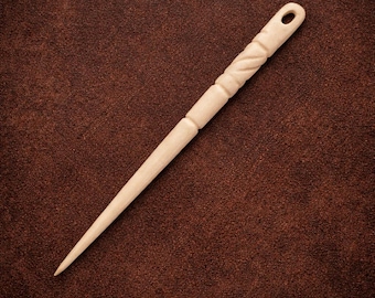 May include: A light-colored wooden hair stick featuring a smooth, tapered point and a handle section with a carved, twisted rope-like texture. The top end of the handle includes a small, circular hole for hanging or decorative purposes.