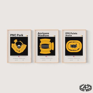 May include: Three framed posters featuring architectural stadium layouts for PNC Park, Acrisure Stadium, and PPG Paints Arena in Pittsburgh, Pennsylvania. Each print displays a yellow stadium diagram on a black background with text.