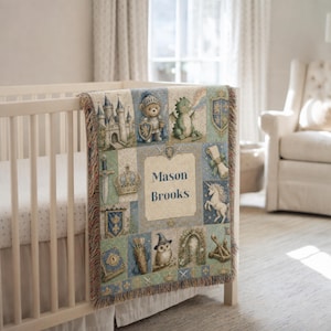 May include: A woven throw blanket featuring a grid of medieval-themed illustrations including a castle, a knight bear, a dragon, a unicorn, an owl, and a scroll. The centre panel displays the name Mason Brooks in dark blue text on a beige background.