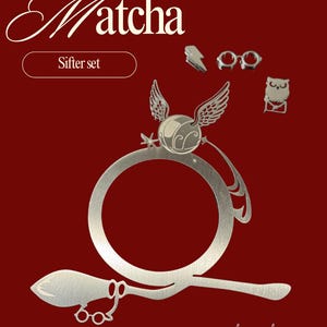 May include: A silver-colored sifter set with a broom, glasses, a winged ball, lightning bolt, glasses, and an owl on a red background. The word "Matcha" is written in a cursive font above the words "Sifter set". The phrase "now gals in love" is written in cursive at the bottom.