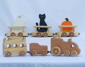 Halloween Train with a black cat, an orange pumpkin, and a white ghost. Heirloom Redwood Train