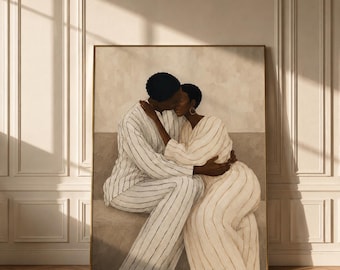 May include: A framed wall art print depicting two individuals with dark skin tones embracing and kissing. One person wears a white suit with thin black vertical stripes, while the other wears a matching white dress with thin black vertical stripes.