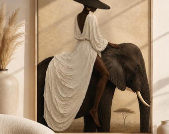 May include: A framed wall art print depicting a person wearing a wide-brimmed black hat and a long, textured white dress, sitting atop a large dark elephant. The background shows a savanna landscape with a single tree under a warm, beige-toned sky.
